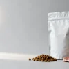 Freeze-dried pet food packaging: a stand-up pouch beside porous freeze-dried meat pieces