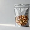 Resealable stand-up nut packaging pouch of mixed nuts with a zipper closure, studio product shot