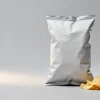 Potato chip packaging: a filled bag with visible headspace beside a small pile of potato chips