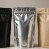 Three stand-up pouches side by side showing matte black, high-gloss metallised and natural kraft film finishes